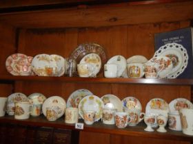 A mixed lot of commemorative ware on two shelves. COLLECT ONLY.