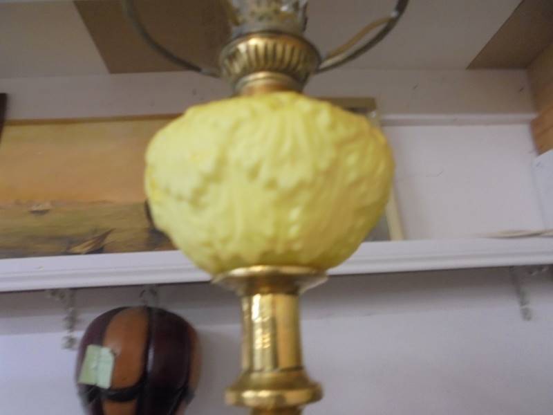 A 19th century brass drop in font candlestick oil lamp with yellow glass font and chimney. - Image 3 of 3