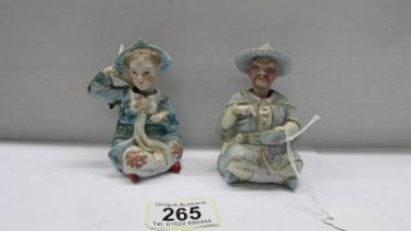 A pair of 19th century porcelain Chinese nodding head figures.