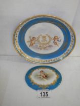 A French porcelain monogrammmed plate a/f (chip to rim) and a smaller plaque.