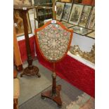 A Victorian mahogany adjustable pole screen with shield shaped panel. COLLECT ONLY.