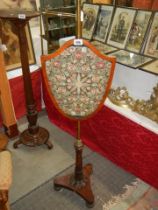 A Victorian mahogany adjustable pole screen with shield shaped panel. COLLECT ONLY.