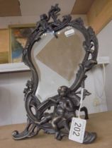 A cast metal framed mirror in the art nouveau style featuring cherubs.