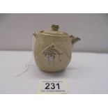 A miniature Chinese hand painted porcelain tea pot.