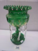 A Victorian green glass hand decorated lustre.
