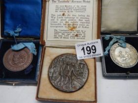 An R M S Lisitania medallion and two attendance medals - 1891 & 1898.