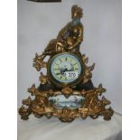 A spelter mantle clock with painted porcelain panels and a battery movement, COLLECT ONLY.