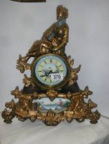 A spelter mantle clock with painted porcelain panels and a battery movement, COLLECT ONLY.
