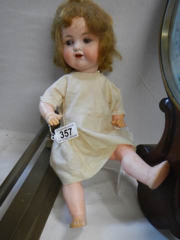 An Armand Marseille porcelain headed doll.