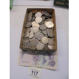 A mixed lot of coins and three Isle of Man bank notes.