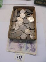 A mixed lot of coins and three Isle of Man bank notes.