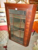 A Victorian mahogany glazed corner cupboard with shaped shelves. COLLECT ONLY.