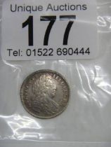 A 1702 Maundy four pence coin.
