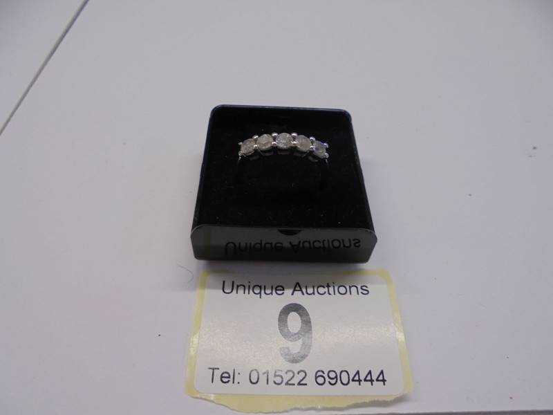 A five stone white gold diamond ring, size N, 4 grams