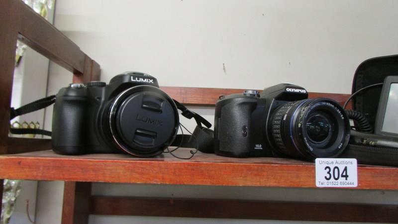 A Lumix camera, an Olympus camera, a camera case and a sat nav. - Image 2 of 2