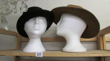 A vintage bowler hat and another vintage hat.