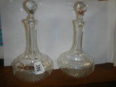 A pair of early 20th century glass decanters, one stopper chipped.