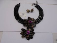 A Butler & Wilson statement necklace and earrings, (flowers 9cm across).