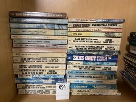 A collection of approximately 32 vintage Zane Grey Western paperbacks