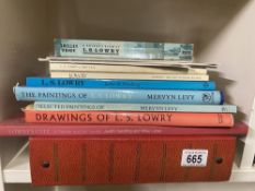 A collection of Lowry related books and an album of Lowry related postcards