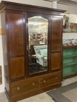 A mahogany inlaid wardrobe with central mirrored door and two drawers, age related marks in