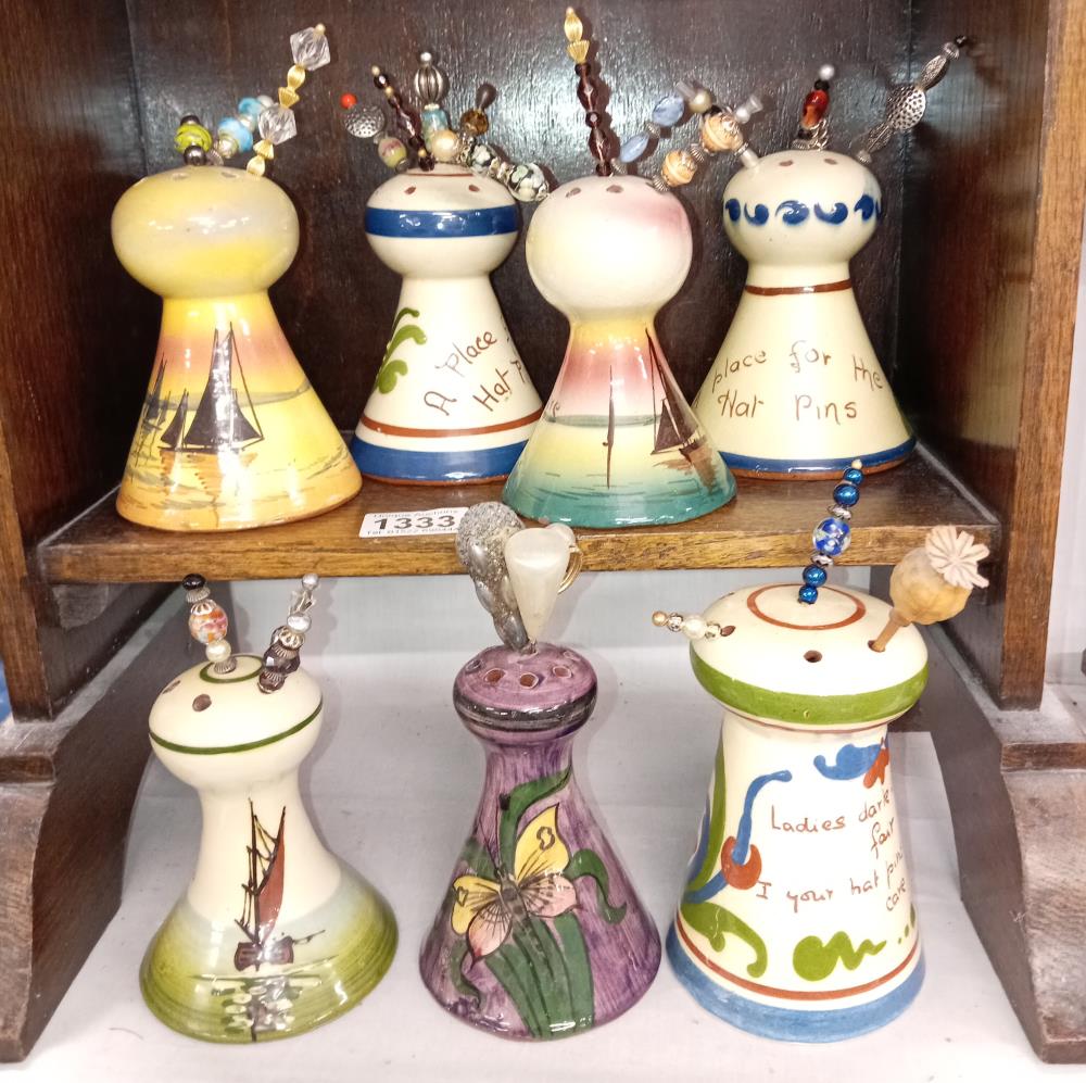 7 Torquay ware hat pin stands