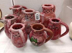 7 pink glazed Barum Barnstaple pottery puzzle jugs