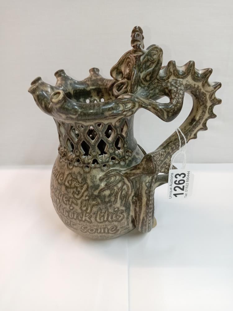 A Studio pottery puzzle jug with dragon handle. Height 22cm