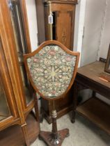 A Victorian mahogany adjustable pole screen with shield shaped panel