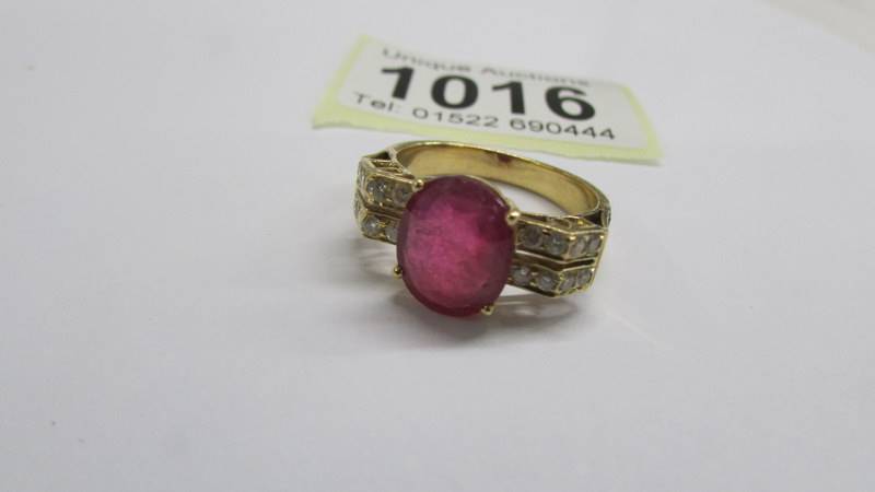 An 18ct white/yellow gold oval ruby and diamond ring, size O half, 6.2 grams. - Image 2 of 2