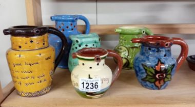 6 Puzzle jugs including Torquay ware