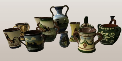 A good collection of 12 handpainted Torquay ware etc jugs, vase etc