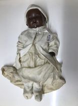 A vintage British made black baby doll (hands a/f).