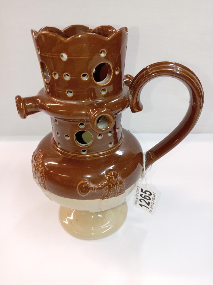 A stoneware pottery puzzle jug. Height 19cm. A/F