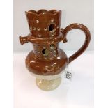 A stoneware pottery puzzle jug. Height 19cm. A/F