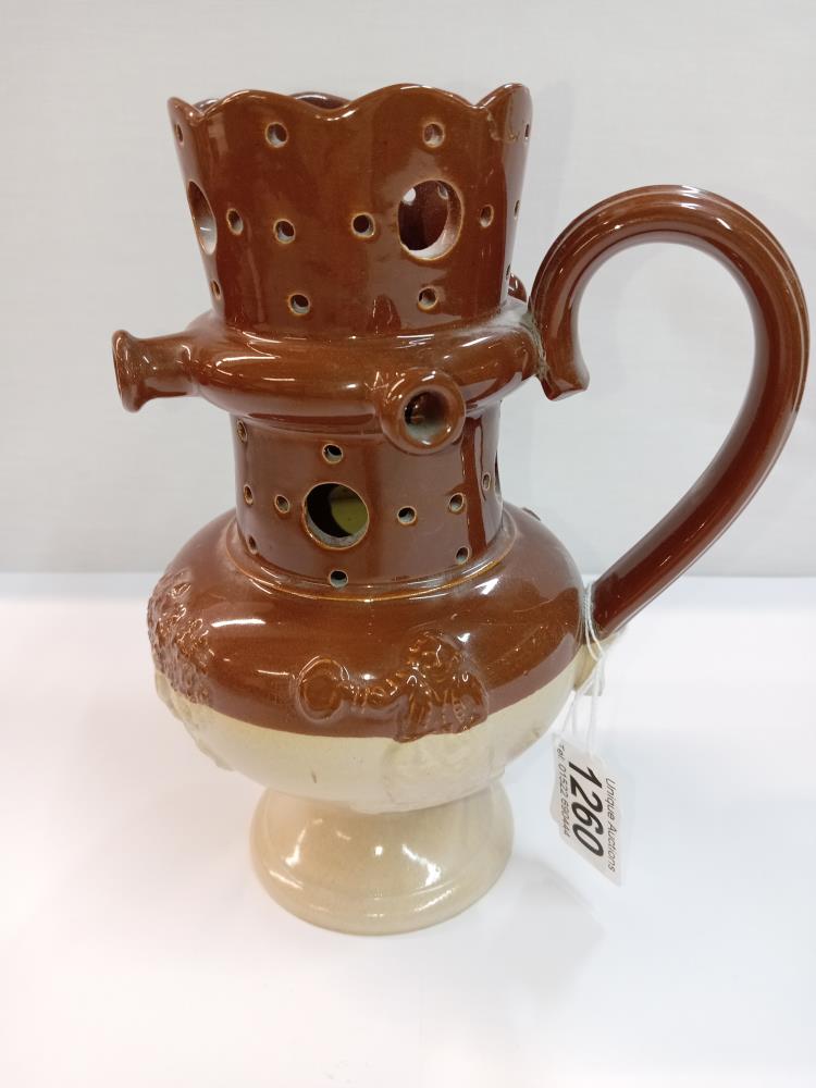 A stoneware pottery puzzle jug. Height 19.5cm. A/F