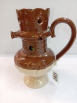 A stoneware pottery puzzle jug. Height 19.5cm. A/F