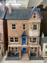A late Victorian style 3 storey and attic dolls house with contents