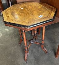 An octagonal string inlaid side table on 4 castered legs (51 x 51 x 60cm)