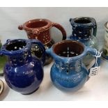 4 puzzle jugs including C M Brannam Barum pottery