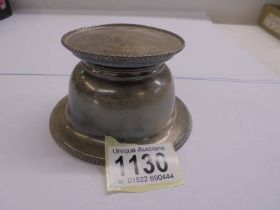 A silver inkwell.