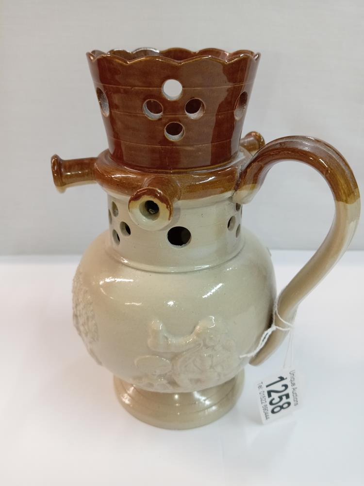 A stoneware pottery puzzle jug. Height 19cm. A/F