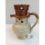 A stoneware pottery puzzle jug. Height 19cm. A/F