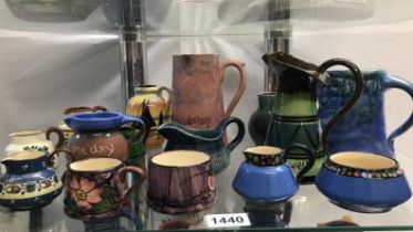 A good collection Torquay ware jugs and Motto ware jugs