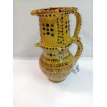 A Bideford pottery double height puzzle jug. Height 24cm