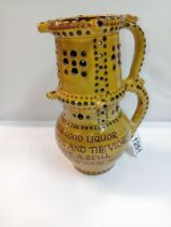 A Bideford pottery double height puzzle jug. Height 24cm