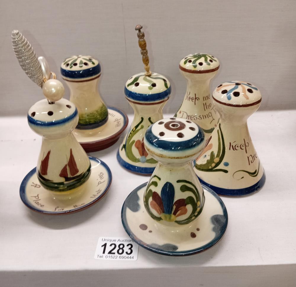 6 Torquay ware hat pin stands including Long Park Watcombe