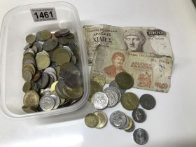 A box of mixed foreign coins and currency