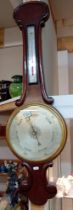 A Victorian barometer with silvered dial