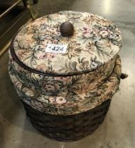 A wicker tapestry sewing box